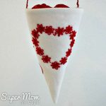 Front-of-fabric-treat-cone-with-red-heart-made-of-embroidered-lazy-daisy-flowers